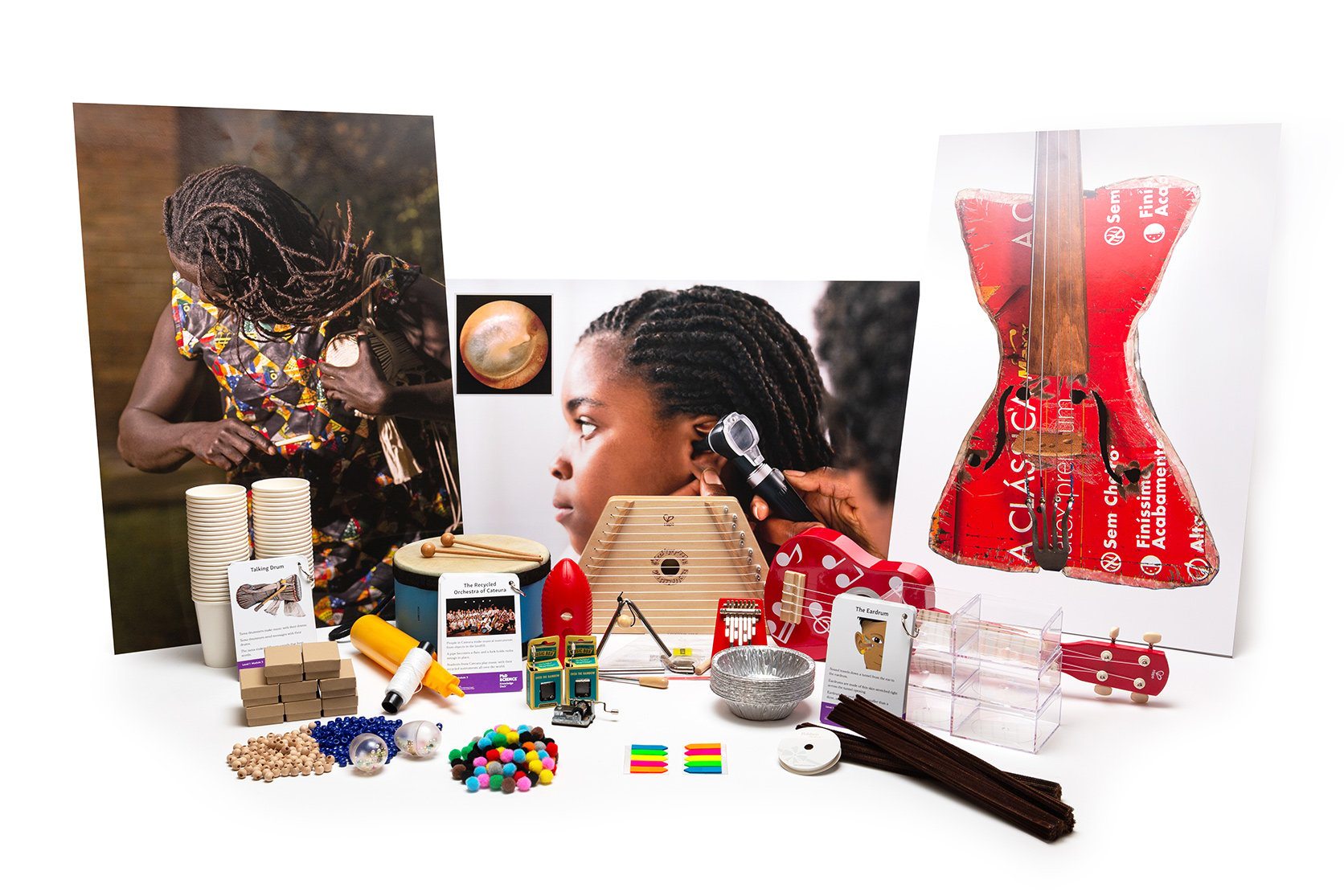 PhD Science hands-on materials kit from Level 1 Module 3 that includes a lap harp, music boxes, Knowledge Deck cards and posters, and pom-poms