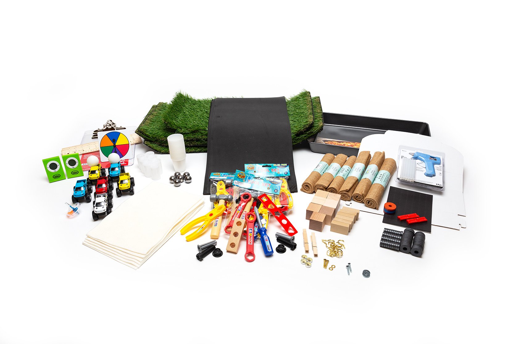 PhD Science hands-on materials kit from Level 3 Module 4 that includes burlap, artificial grass, a game spinner, and toy cars