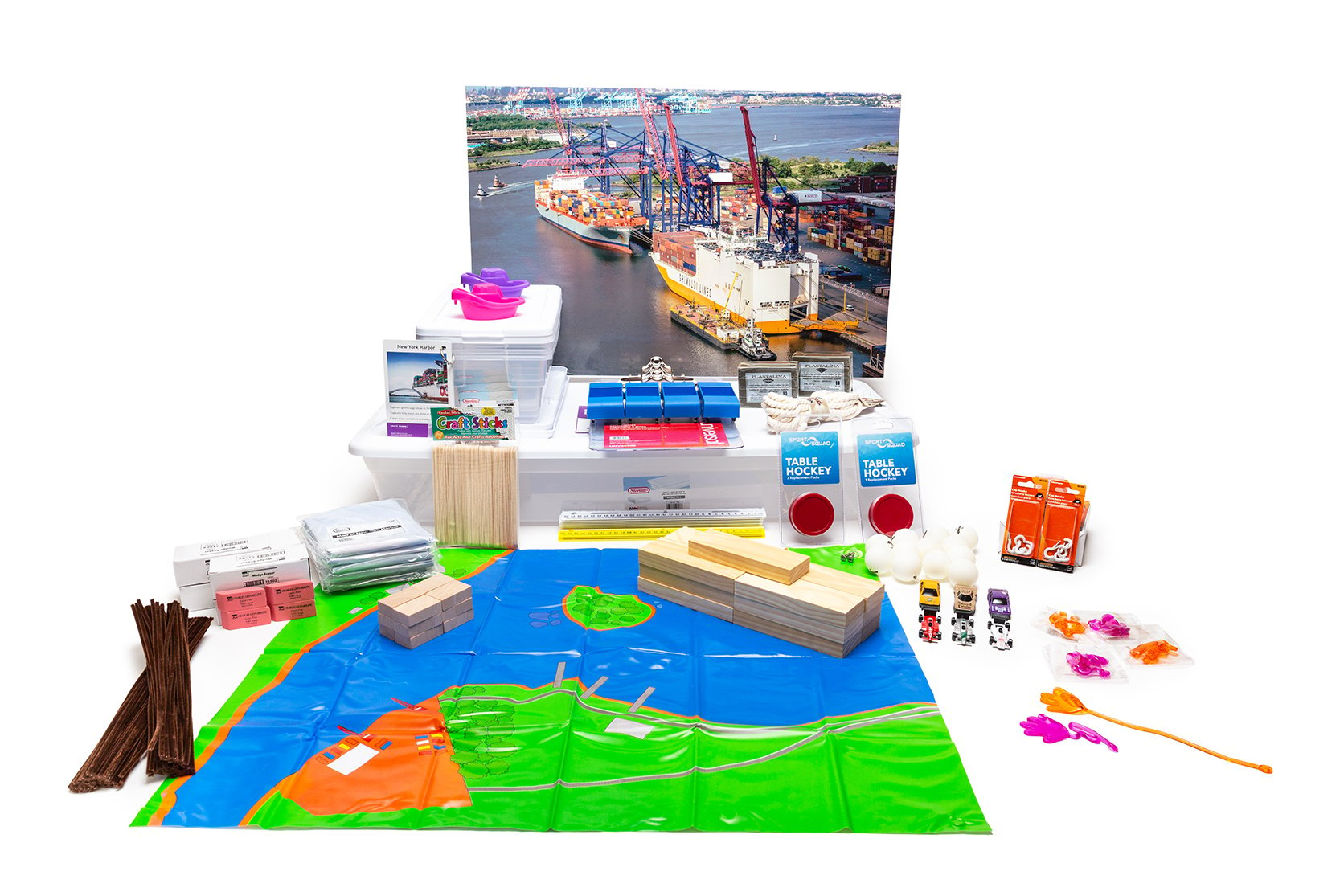 PhD Science hands-on materials kit from Level K Module 2 that includes vinyl harbor maps, wooden blocks, and Knowledge Deck cards and poster
