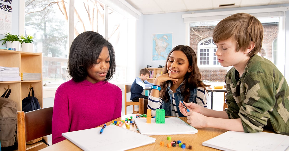 Three students cube counting during a math lesson.