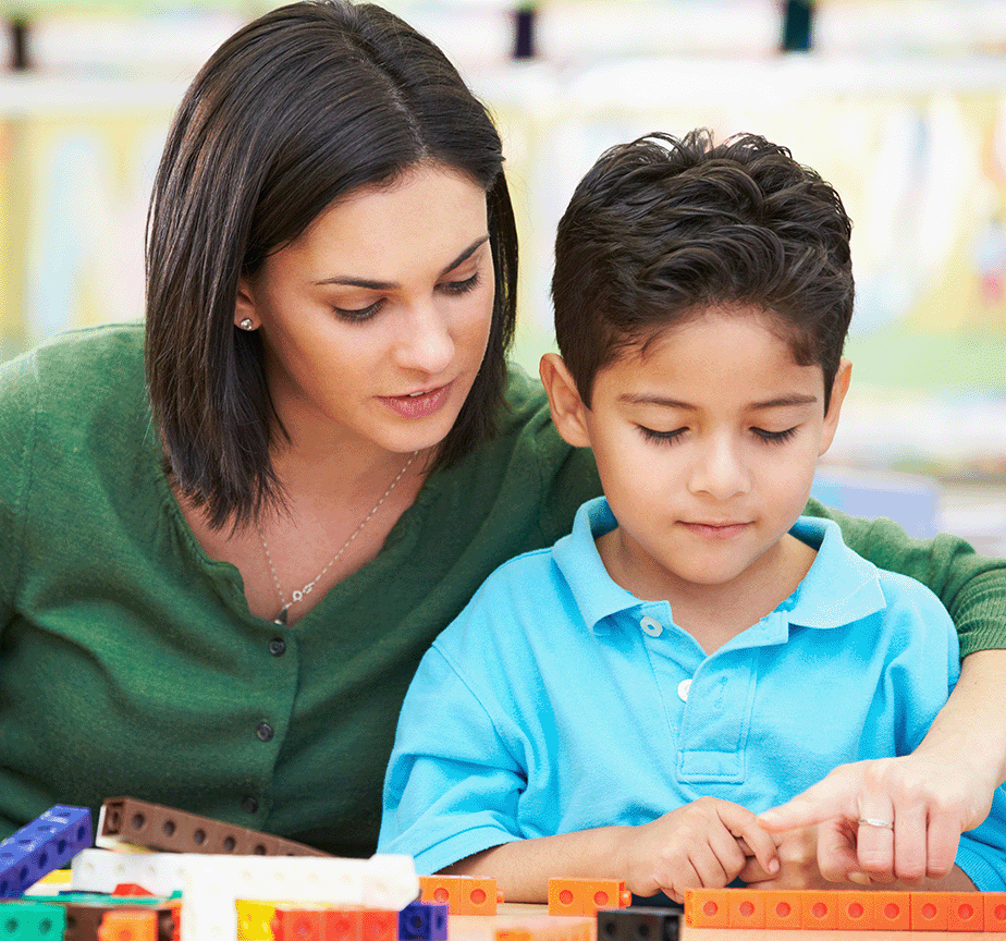 EN- Teacher helping Latino Boy Counting Cubes-Shutterstock-SMALL