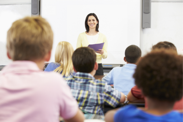 An educator standing in front of a class of students