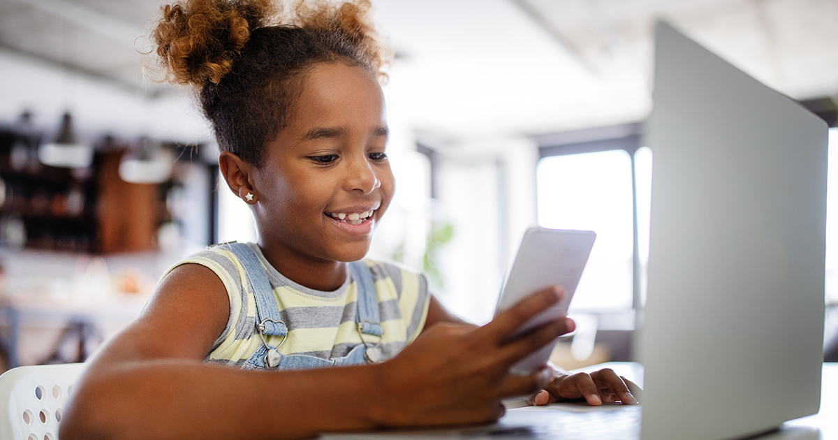 Smiling girl looking at phone.