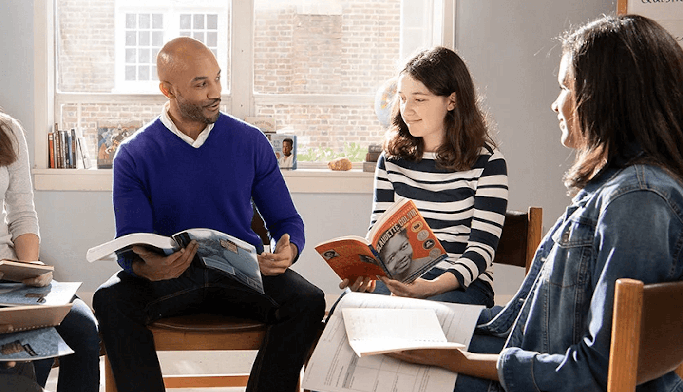 A teacher leads group discussion of a middle school book.